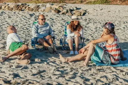 group-of-people-sitting-onbeach